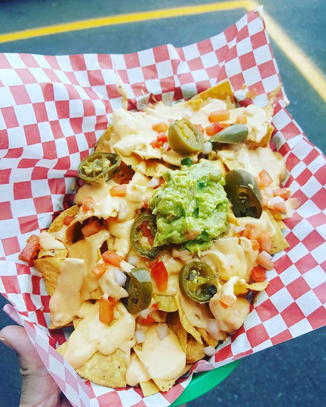 Nachos · House made chips smothered is creamy queso, pickled jalapenos , pico de gallo and topped with your choice of protein.
