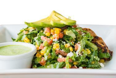 Chili Lime Chicken Salad · Grilled chicken seasoned with our chili lime rub and tossed with shredded romaine, pico de gallo, avocado, grilled corn, Cotija cheese, and our house made green goddess dressing.