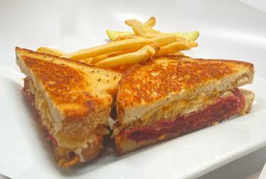 New York Reuben · Grilled corned beef, sauerkraut, Swiss cheese, and Thousand Island spread on rye.