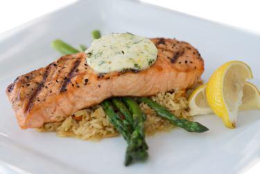 Grilled Atlantic Salmon · Broiled salmon filet topped with citrus butter on a bed of rice pilaf and served with grilled asparagus.