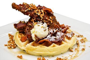 B&B Waffle w/ Pretzel Chicken · Pretzel crusted fried chicken and a Belgian waffle topped with Siracha candied bacon, toasted pecans and powdered sugar. Served with bourbon maple syrup