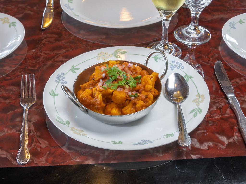 Aloo Gobhi Masala · Cauliflower & potatoes cooked with tomato, onion, herbs & spices garnished with fresh coriander.