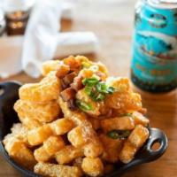Loaded Tater Tots · Smothered in cheddar beer sauce and topped with diced smoked pork belly and green onions.