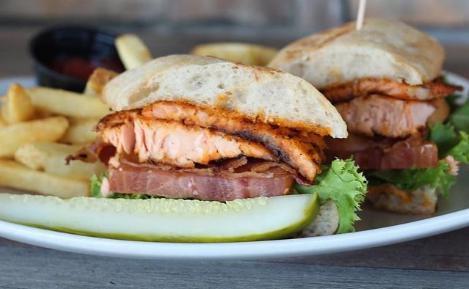 Salmon BLT Sandwich · Seared salmon served with chipotle aioli, lettuce, tomato, and bacon on ciabatta.