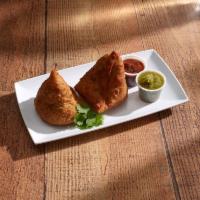 Samosa · Triangular pies stuffed with potatoes and peas, tempered with spices.