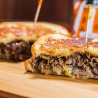 Southwestern Tri Tip · Marinated tri tip served on parmesan-crusted sourdough with a blend of cheddar and pepper ja...