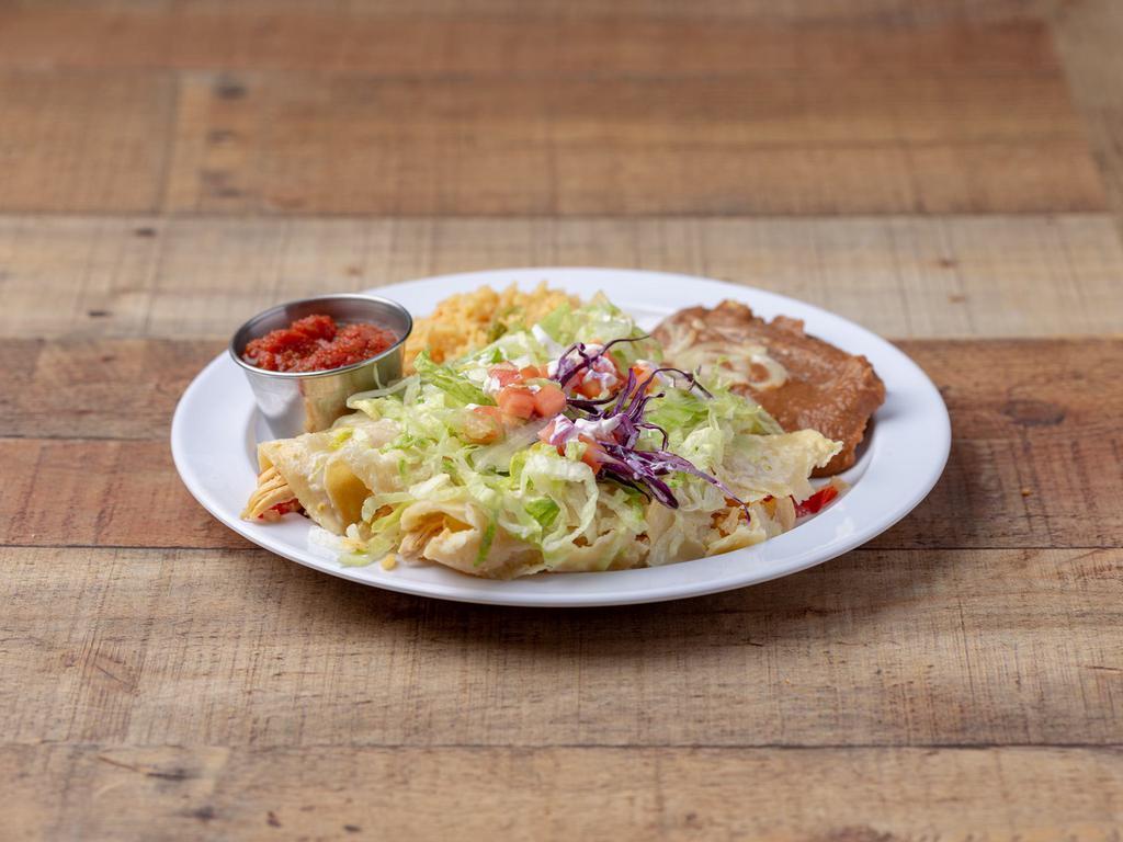 Enchiladas Suizas · 3 chicken enchiladas with cheese dip on top. Served with rice and beans, lettuce, tomatoes and sour cream.