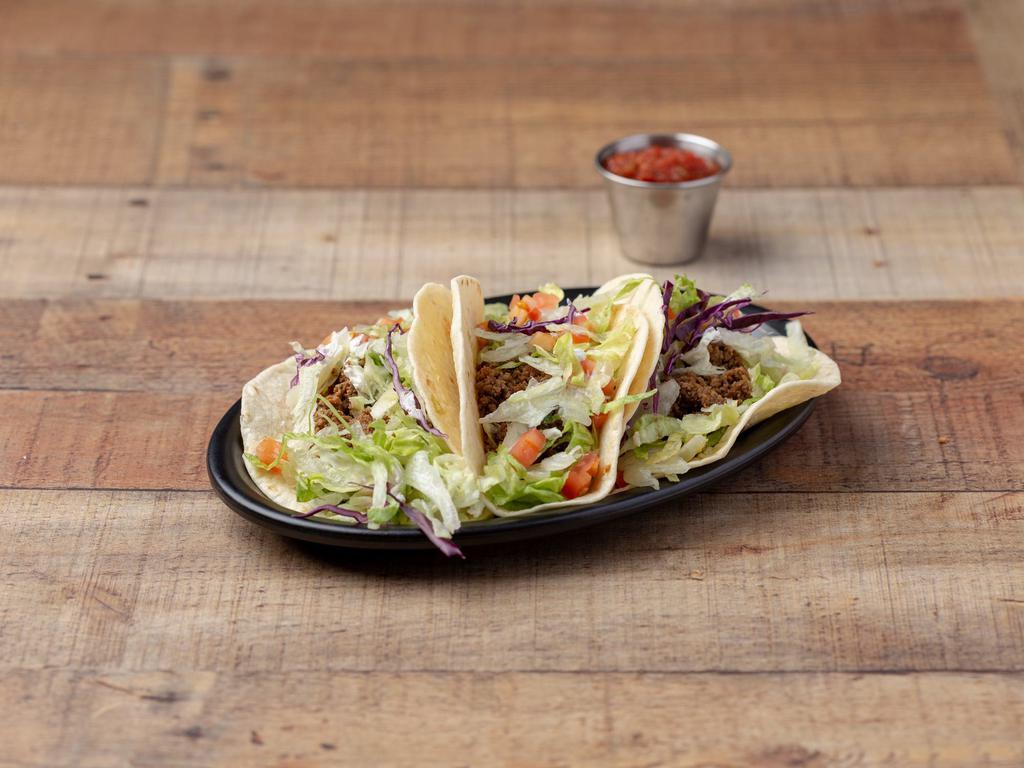 Tacos Supremos · 3 soft tacos with ground beef, lettuce, red salsa, tomato and sour cream.