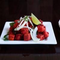 Paneer 65 · Cottage cheese. A spicy deep fried appetizer, garnished with onions and cilantro.