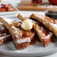 Brioche French Toast · French Toast dusted with powdered sugar with whipped margarine and maple syrup.