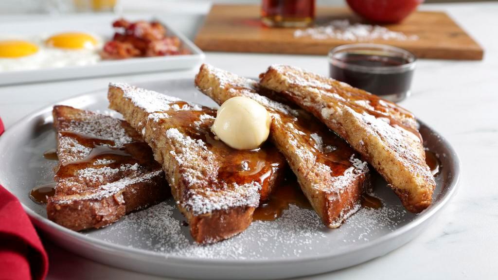 Brioche French Toast · French Toast dusted with powdered sugar with whipped margarine and maple syrup.