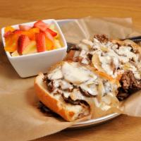 Philly Cheese Steak Sandwich · Shaved Angus beef, piled high with caramelized onion, mushrooms and topped with our signatur...