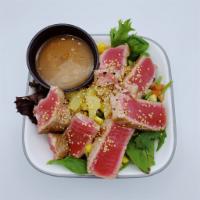 Seared Ahi Salad  · Sliced, pan seared sashimi grade ahi, pineapple, cucumber, tomato, wonton strips, and mango ...