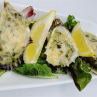 Oysters Rockefeller · Oysters roasted with spinach, capers, garlic, Parmesan cheese and butter.