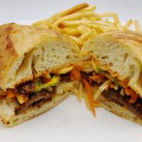 Banh Mi Char Sui Pork · Served with pickled daikon and carrots, sliced jalapenos, onions, cilantro and topped with a...