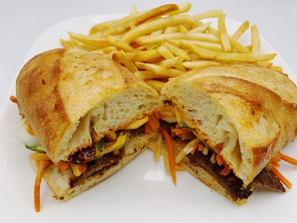 Banh Mi Bulgogi Beef · Served with pickled daikon and carrots, sliced jalapenos, onions, cilantro and topped with a Sriracha aioli and served on a fresh French baguette. Served with fries or substitute fries for side item.