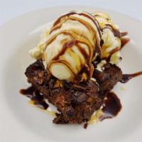 Rockslide Brownie · Baked brownie with another brownie crumbled on top with caramel sauce. Topped with vanilla i...