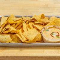 Chips and Queso · 8 oz. queso served with our fresh, homemade chips! We fry a fresh batch of chips for every o...