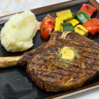 Bone-in Ribeye (20 Oz.) · Chefs Seasonal Vegetables / Roasted Potatoes / Steak Butter