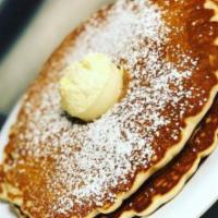 Lincoln Square Pancakes · Three fluffy pancakes dusted with powdered sugar & topped with our whipped butter.