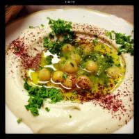 Hummus · A blend of chickpeas with tahini sauce, lemon, salt and served with pita bread.
