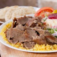 Gyro Platter Dinner · Gyro meat over rice with a side Greek salad.