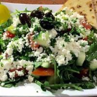 Arugula Salad · Arugula tossed with tomatoes, olives, cucumber, green and red pepper, Parmigiano cheese and ...
