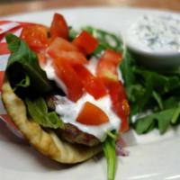 Gyro on a Pita · Lamb-beef or chicken gyro on pita with feta cheese, arugula, tomato, olive and grape tzatzik...