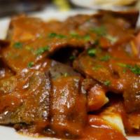 Iskender Doner · Gyro platter. Thin cuts of lamb-beef gyro meat over pieces of pita with warm homemade Turkis...