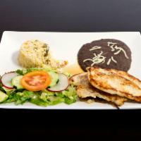 Pechugas a la Plancha · Grilled chicken breast served with rice and beans.