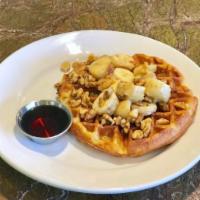 Belgian Waffle · Buttermilk waffle with bananas, walnuts and butter with a side of maple syrup.
