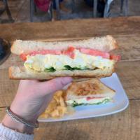 Egg Salad Sandwich · Table bread, egg salad, and mayo with lettuce and tomato.