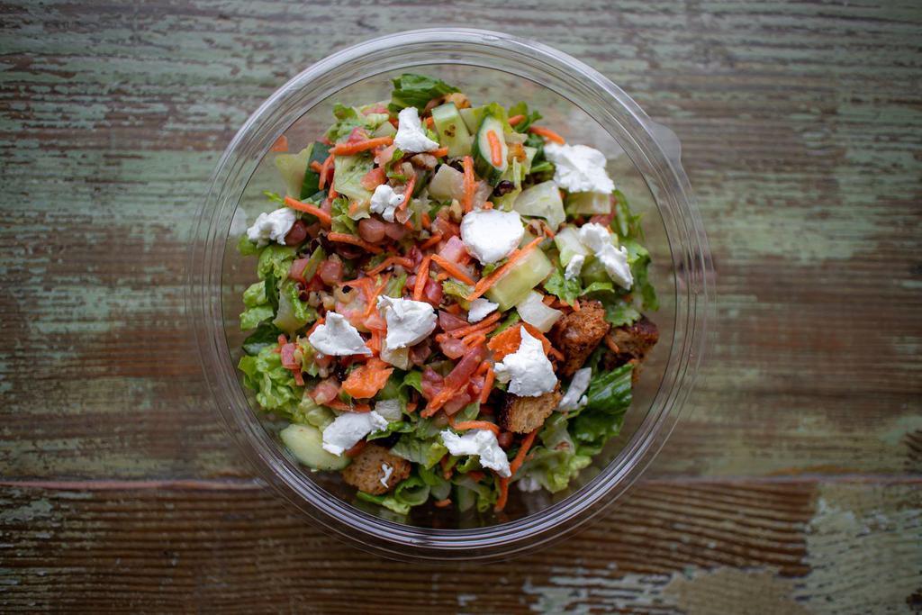 Chopped Farm Table Salad · Chopped Romaine, vegetables, grape tomatoes, walnuts, First Light Farms goat cheese, and croutons tossed with a lemon vinaigrette.