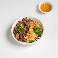 33. Bun Tom Thit Nuong · Grilled pork and shrimp over rice stick noodle and vegetables.
