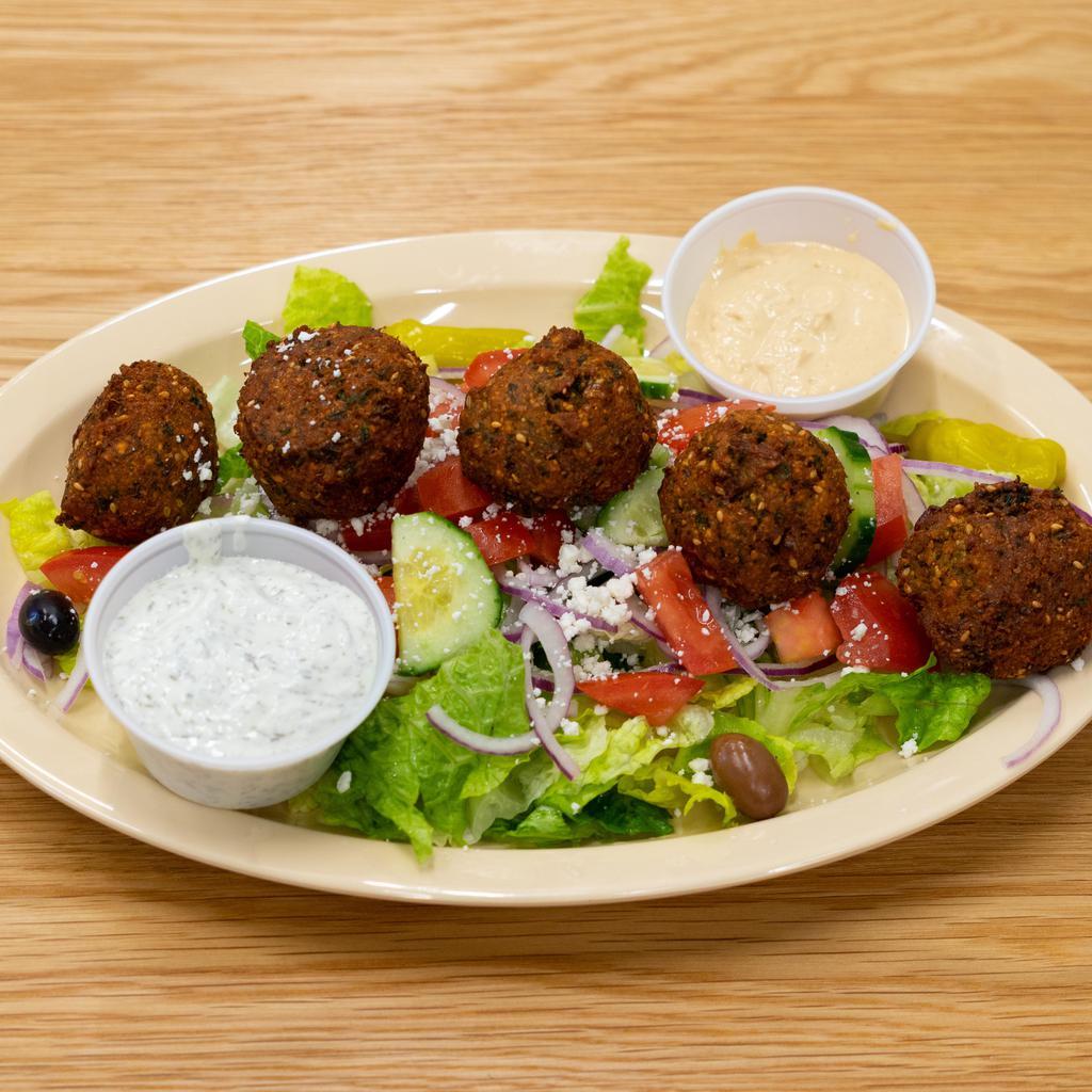 13. Veggie Mix Plate · Falafel, hummus and baba ganouj served with Greek salad, bread and tzatziki sauce.