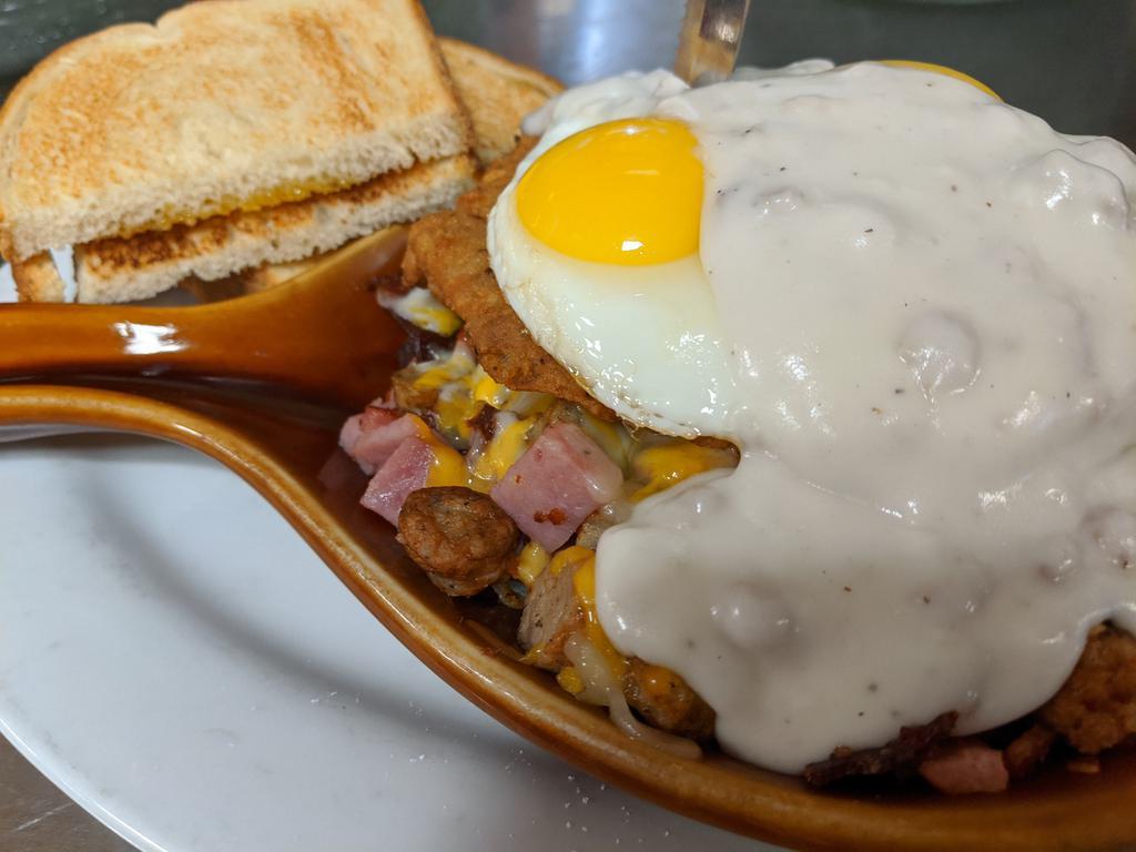 Meat Lovers Skillet · Chicken fried steak, bacon, sausage, ham and sausage gravy. Topped with 2 eggs, melted cheese, hash browns, and English muffin.
