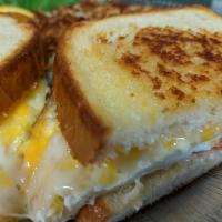 Breakfast Sandwich · Bacon, 2 fried eggs, cheese, tomatoes, mayonnaise on grilled sourdough.