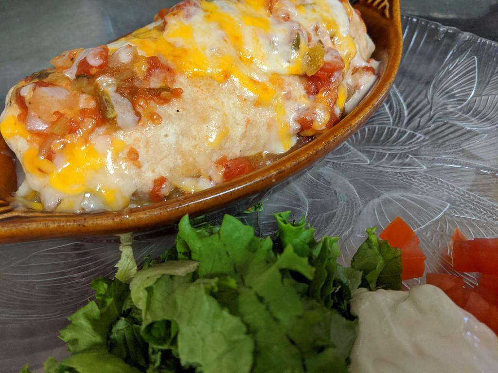 Sonora Burrito · Chorizo, eggs, green chilies, onions, salsa, cheese, garnished with tomatoes, lettuce, and sour cream.
