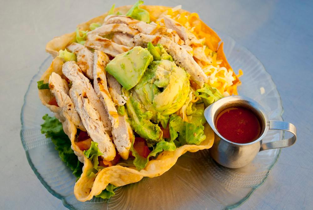 Chicken Taco Salad · Chicken, tomatoes, avocado, cheese, sour cream, fried tortilla shell with salsa.