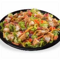 Crispy Chicken Salad · Our signature chicken strips, served hot and crispy, diced and placed on a crisp blend of ro...