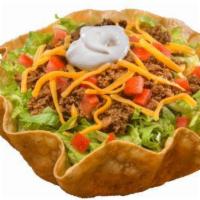 Beef Taco Salad · Crispy tortilla bowl filled with seasoned beef, refried beans, shredded cheddar cheese, cris...