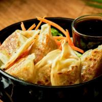 Gyoza · 8 pieces. Pan fried leek and chive dumpling served with garlic soy sauce.