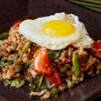 Yummy Gra Pow Moo · Served hot and spicy. Minced pork sauteed with chili basil sauce served with fried sunny sid...