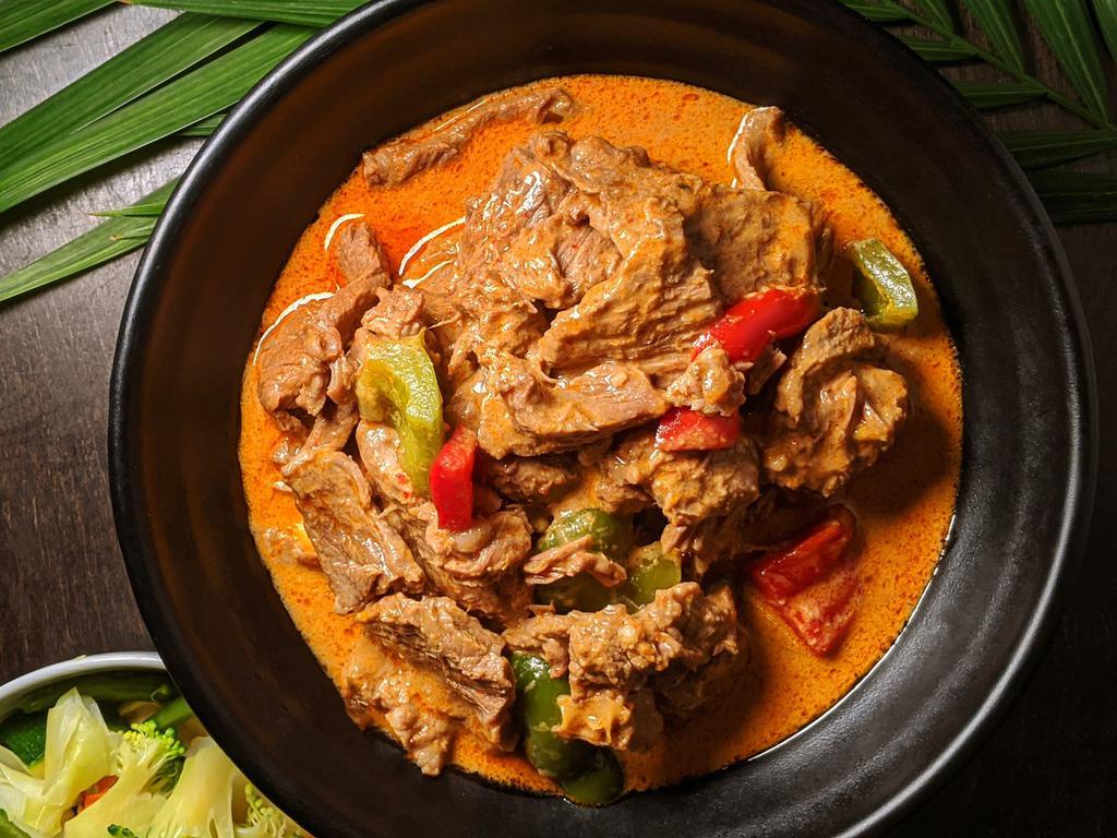 Panang Thai · NY times. Homemade panang curry paste, beef, peanut butter, and hot pepper in coconut milk served with steamed vegetable and jasmine rice.
