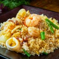 Thai Party Fried Rice · Stir-fried rice combination of chicken, squid, shrimp, carrot, onion, and egg.