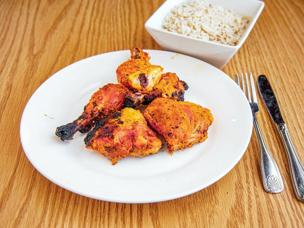 Tandoori Chicken · Tender chicken marinated in yogurt and spices then baked on skewers in our clay oven.