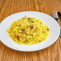 Lemon Rice · Long grain lemon flavored basmati rice steam cooked with peas and mustard seeds.