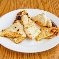 Naan · Traditional Punjabi unleavened white flour bread baked in our tandoor.