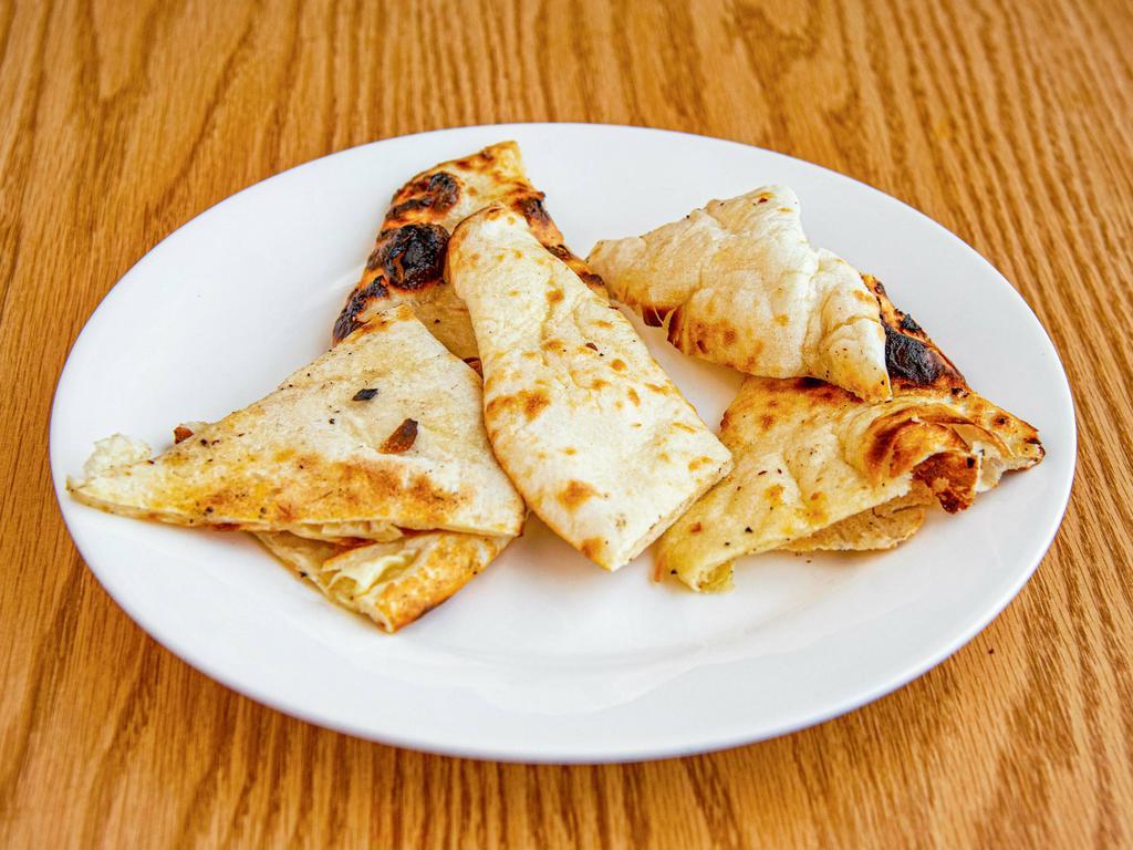 Naan · Traditional Punjabi unleavened white flour bread baked in our tandoor.