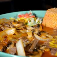 Steak Picado · Top sirloin sliced and sauteed with onions, mushrooms and onions covered with Spanish sauce....